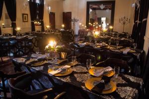 a dining room with tables and chairs with candles at Premier Hotel and Spa Cullinan in Cullinan