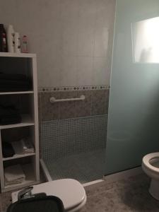 a bathroom with a shower and a toilet at Apart Juan de Cardona in Arinaga +8 photos
