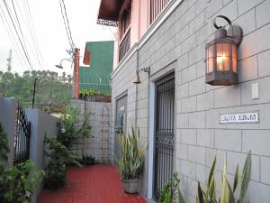 un edificio con una puerta y una pasarela de ladrillo rojo en Casita Aurora Bed and Breakfast, en Legazpi