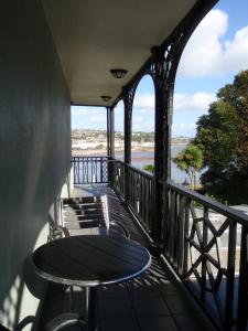 a balcony with a table and chairs and a bridge at The Ness in Teignmouth
