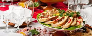 a table with a plate of food and a salad at Hotel Grande Residency in Jaipur