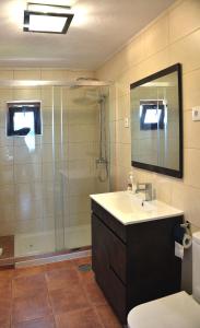 a bathroom with a shower and a sink and a toilet at Casa Da Eira Longa in Vilar