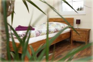 a bedroom with a bed with a night stand and a window at Ferienhaus Strandperle in Garrel