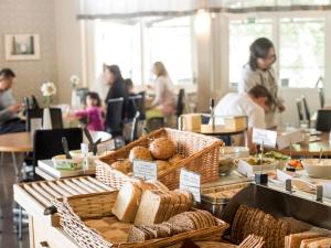 a bakery with bread and pastries on a counter at Hotell Svanen in Kalmar