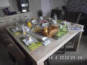 uma mesa com comida na cozinha em B&B Hoeven Het Gehucht em Overpelt
