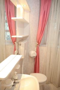 a bathroom with a white sink and a red shower curtain at Old town Kotor Square in Kotor