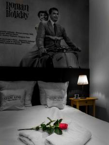 una foto en blanco y negro de un hombre en una cama en Cinema Rooms - Piotrkowska, en Łódź