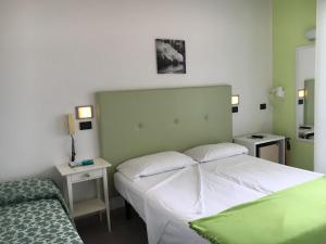 Łóżko lub łóżka w pokoju w obiekcie San Giorgio Savoia