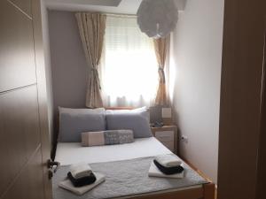 a bedroom with a bed with two towels on it at Apartment Cerska MRB in Belgrade