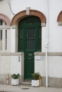 a white door leading to a building with a blue door at O'Porto Seven - Guest House in Porto
