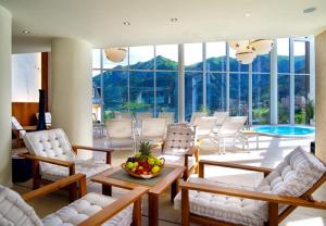 a living room with chairs and a table with a bowl of fruit at Villa Orania in Bad Gastein