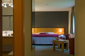 Rúm í herbergi á Cocoon Hotel Belair