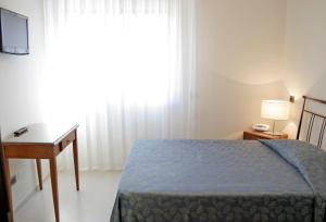 Postel nebo postele na pokoji v ubytování Hotel Sorriso