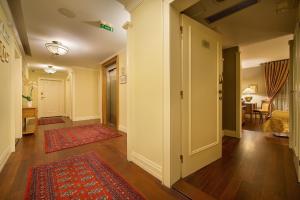 A bed or beds in a room at Marrol's Boutique Hotel