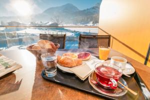 a tray of breakfast food on a table with drinks at Ferienwohnungen Guthof in Schattwald