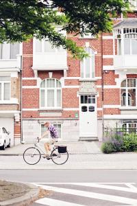 a person riding a bike down the street at B&B Villa des Roses in Hasselt