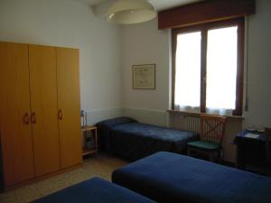 מיטה או מיטות בחדר ב-Il Lorì di Alessandra