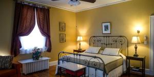a bedroom with a bed and a couch and a window at King George Inn in Roanoke