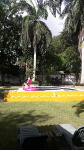 a girl on a pink float in a pool at Ch'ejum bungalow in Cancún