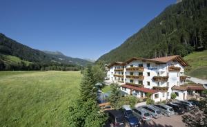 arial view of a hotel with cars parked in a field at Hotel Bergblick in Racines