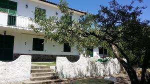 a white fence in front of a house at Case Sole e Luna in Porto Azzurro