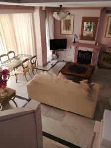 a living room with a couch and a fireplace at Marbella House in Marbella