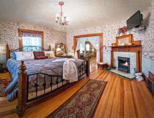 a bedroom with a bed and a fireplace at Holden House 1902 Bed & Breakfast Inn in Colorado Springs