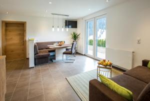 a living room with a couch and a table at Apart Thurner in Kappl
