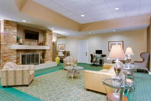 eine Lobby mit Sofas und Kamin sowie ein Wohnzimmer in der Unterkunft Ramada by Wyndham Provo in Provo