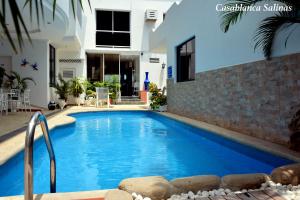 a swimming pool in front of a house at Hotel Casablanca Salinas in Salinas +16 photos