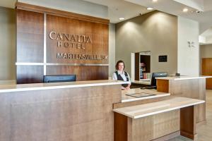 a woman standing in front of a hotel lobby at Canalta Selkirk in Selkirk