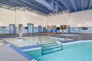 a swimming pool with a fountain in a building at Canalta Selkirk in Selkirk