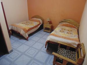 Postel nebo postele na pokoji v ubytování Hostal Coronel Pedro Arraya