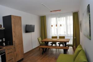 a living room with a dining room table and chairs at Apartment an den Quellen in Wiesbaden