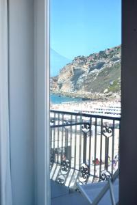 a view of a beach from a room with a window at Hotel Mar Bravo in Nazaré