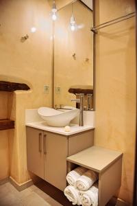a bathroom with a sink and a mirror at Villa Kapela in Sívas