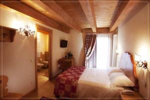 Postel nebo postele na pokoji v ubytování Garnì Astoria Hotel & SPA