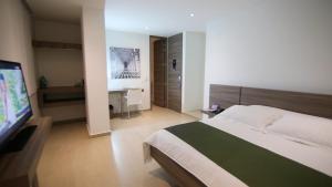 Ένα ή περισσότερα κρεβάτια σε δωμάτιο στο BGA Hotel