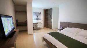 Ένα ή περισσότερα κρεβάτια σε δωμάτιο στο BGA Hotel