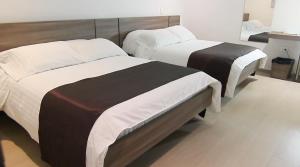 Ένα ή περισσότερα κρεβάτια σε δωμάτιο στο BGA Hotel