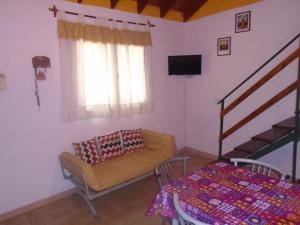 a living room with a couch and a table at Duplex Valeria del Mar in Valeria del Mar