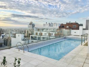 a swimming pool on the roof of a building at Departamentos Mediterraneo in Córdoba