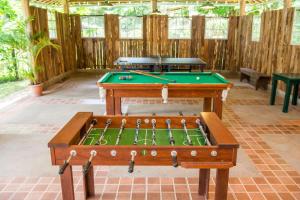 a ping pong table with a pool table at Hotel Solar dos Montes in Santana dos Montes