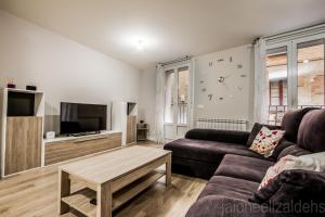 a living room with a couch and a coffee table at Apartamento Buen Camino in Pamplona