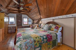 a bedroom with a bed and a ceiling fan at Noble Suites in Brockville