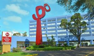 a large red sculpture in front of a building at Best Western PLUS Gran Hotel Morelia in Morelia