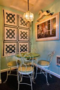 a dining room with two chairs and a table at Sandy Cove Inn in Seaside