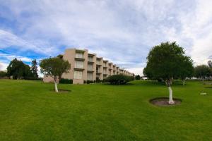 a large building with two trees in a grassy field at Hotel Parador Zacatecas in Zacatecas