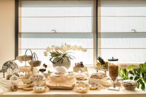 a table with food and other items on it at Draconerium Hotel in Dronero