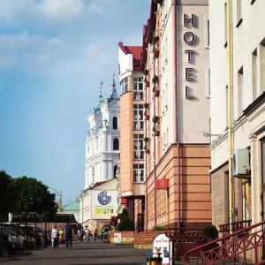 a group of buildings on a street with a clock tower at Apartment on Sovetskaya 3 in Grodno